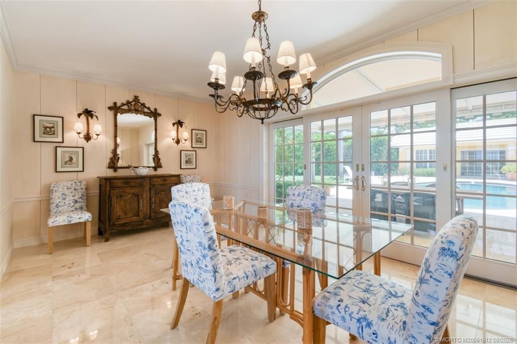 485 South Beach Road Hobe Sound, FL 33455 - Photo 26 of 72 a dining room with furniture a chandelier and window