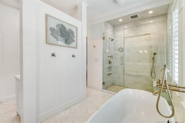 a spacious bedroom with a bed and wooden floor