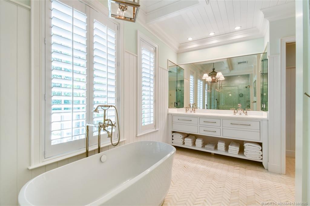 485 South Beach Road Hobe Sound, FL 33455 - Photo 36 of 72 a bathroom with a tub and a large window