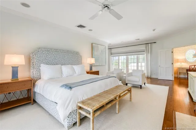 a bedroom with a large bed and a large window