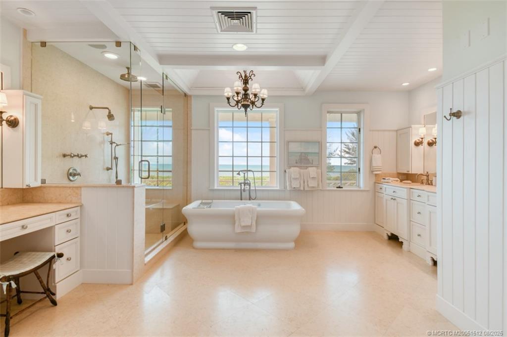 485 South Beach Road Hobe Sound, FL 33455 - Photo 48 of 72 a large bathroom with a double vanity sink a toilet a bathtub and shower