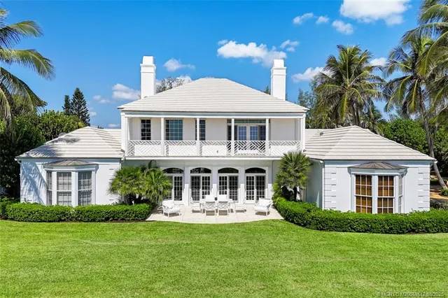 a view of a house with patio and a garden