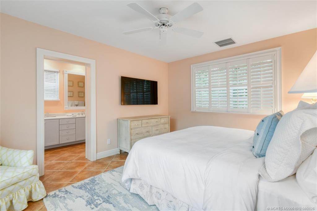 485 South Beach Road Hobe Sound, FL 33455 - Photo 62 of 72 a spacious bedroom with a bed and a flat screen tv