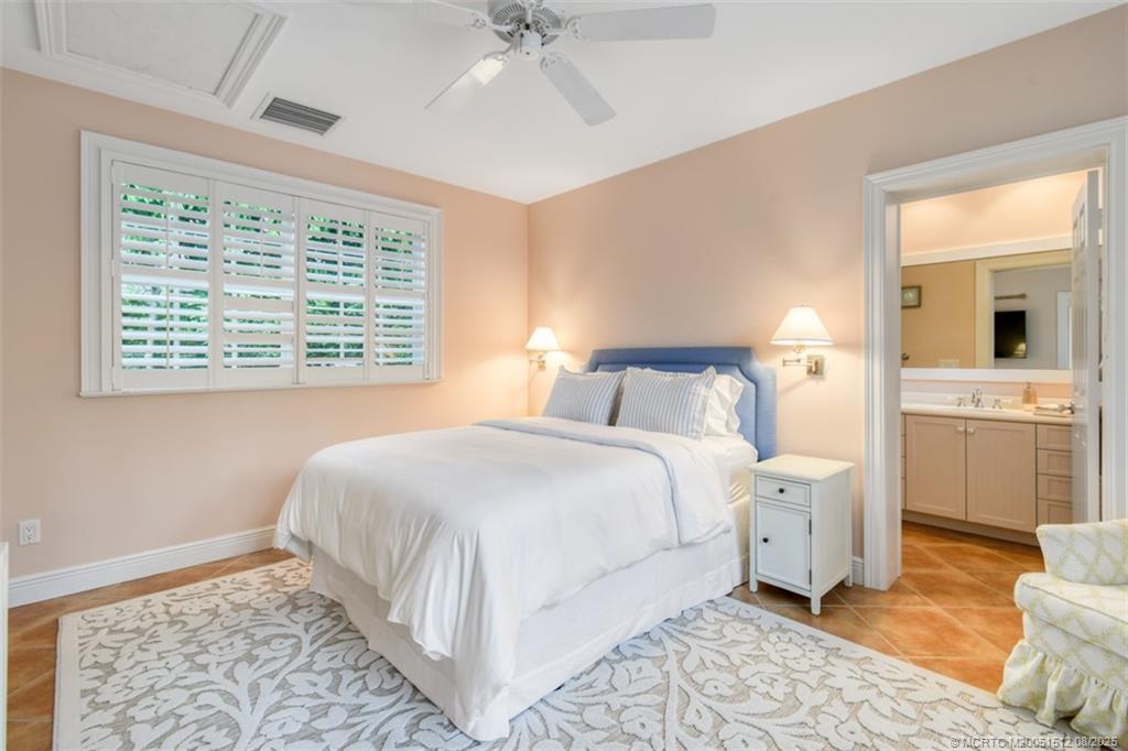 485 South Beach Road Hobe Sound, FL 33455 - Photo 65 of 72 a bedroom with a bed and a chandelier