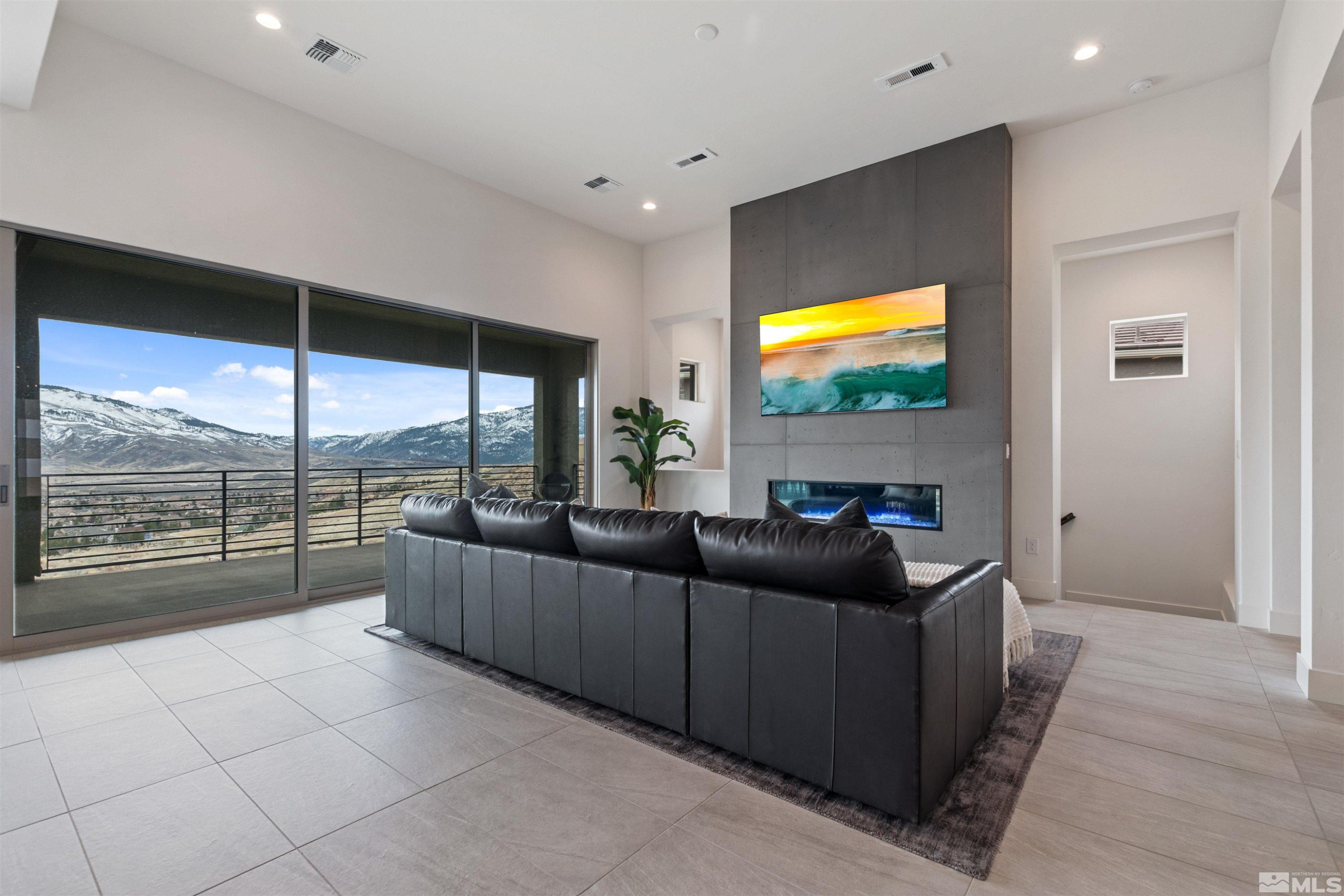 9110 Wild Skies Way Reno, NV 89523 - Photo 15 of 46 a living room with furniture and a flat screen tv