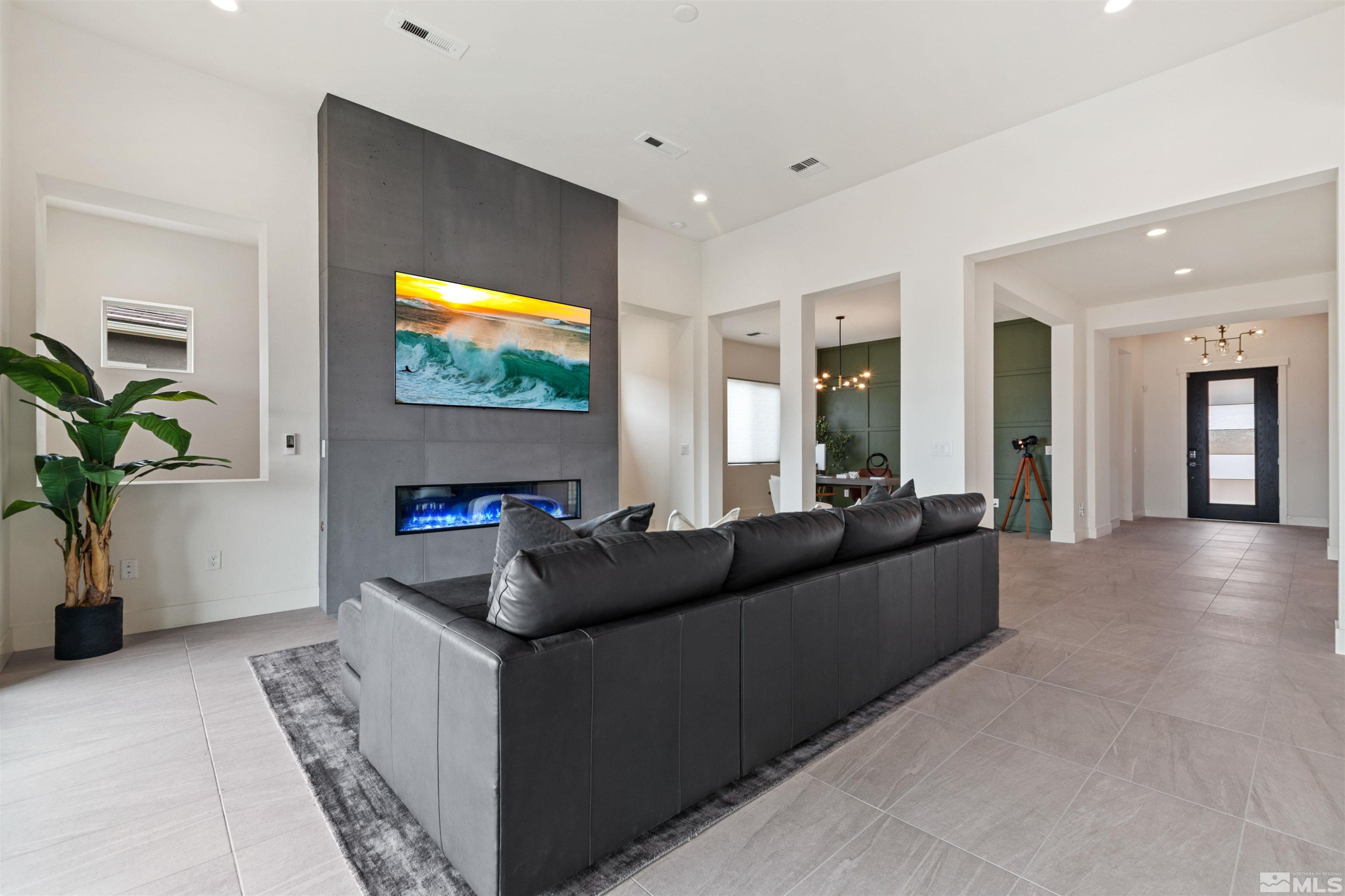 9110 Wild Skies Way Reno, NV 89523 - Photo 17 of 46 a living room with furniture and a flat screen tv