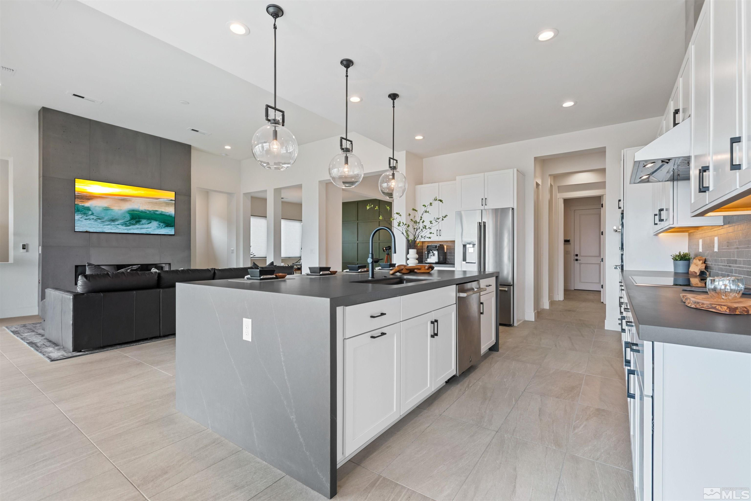 9110 Wild Skies Way Reno, NV 89523 - Photo 22 of 46 a large kitchen with stainless steel appliances kitchen island granite countertop a sink a stove and a refrigerator