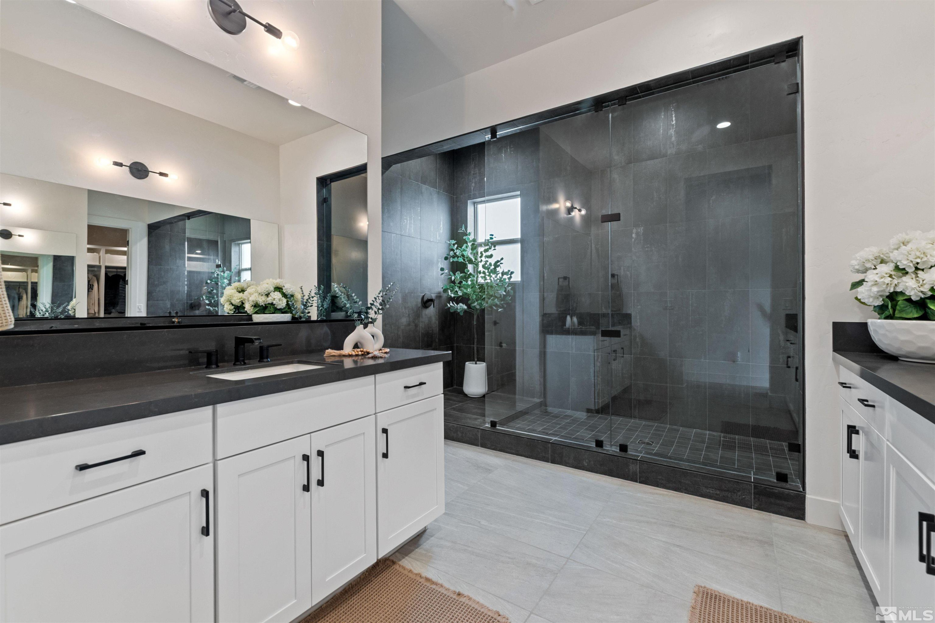 9110 Wild Skies Way Reno, NV 89523 - Photo 26 of 46 a spacious bathroom with a shower sink and mirror