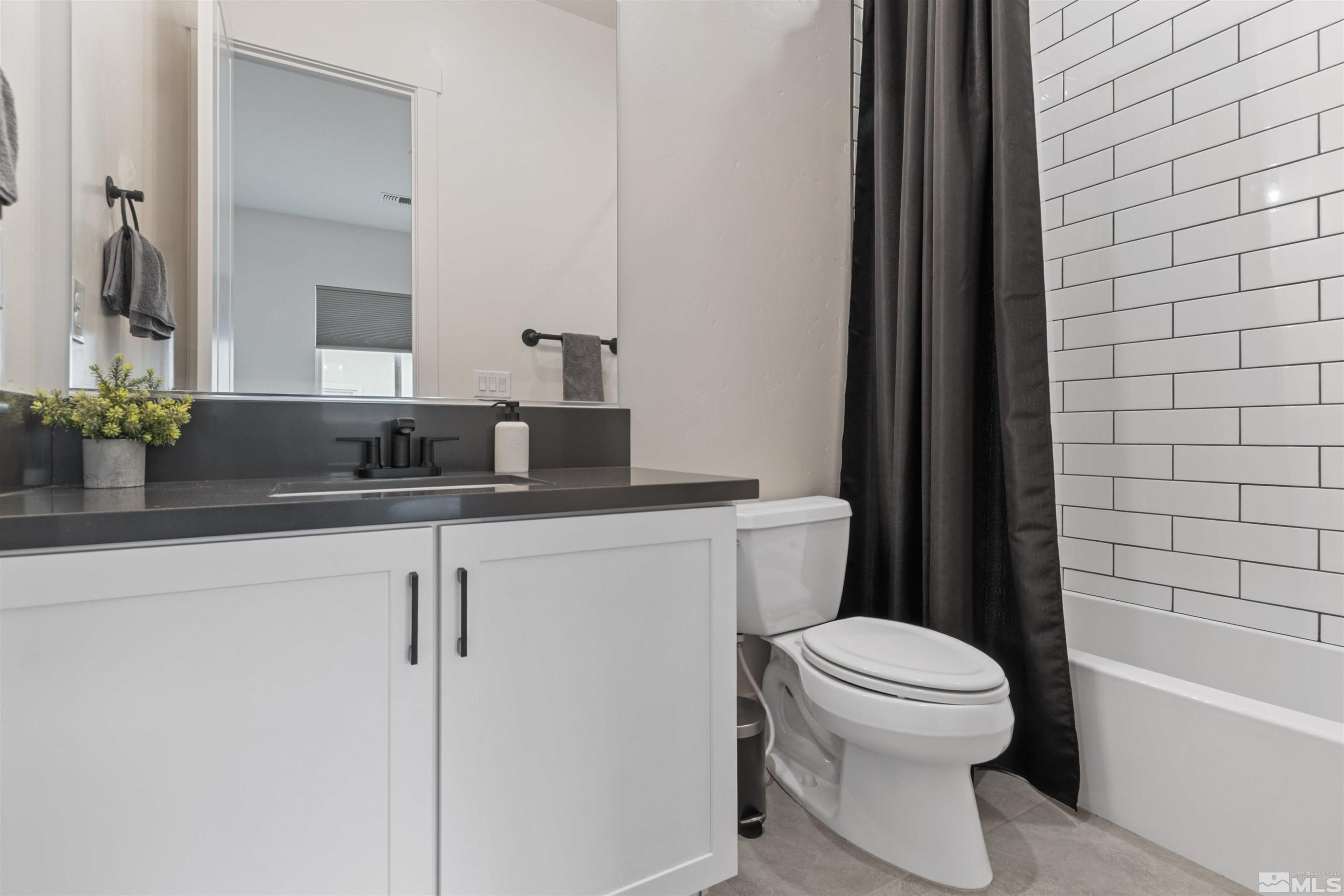 9110 Wild Skies Way Reno, NV 89523 - Photo 30 of 46 a bathroom with a toilet a sink and a bathtub