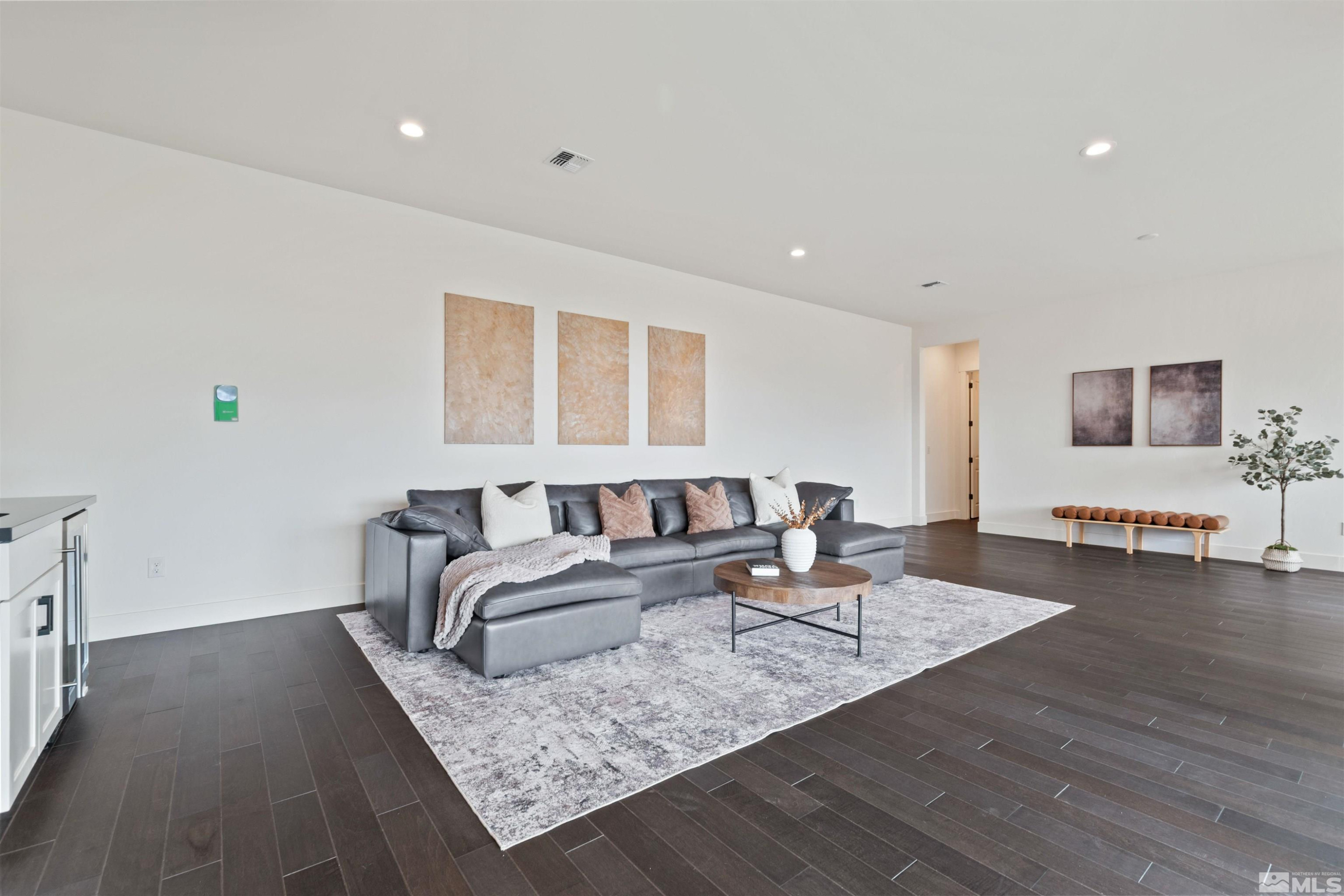 9110 Wild Skies Way Reno, NV 89523 - Photo 32 of 46 a living room with furniture and wooden floor