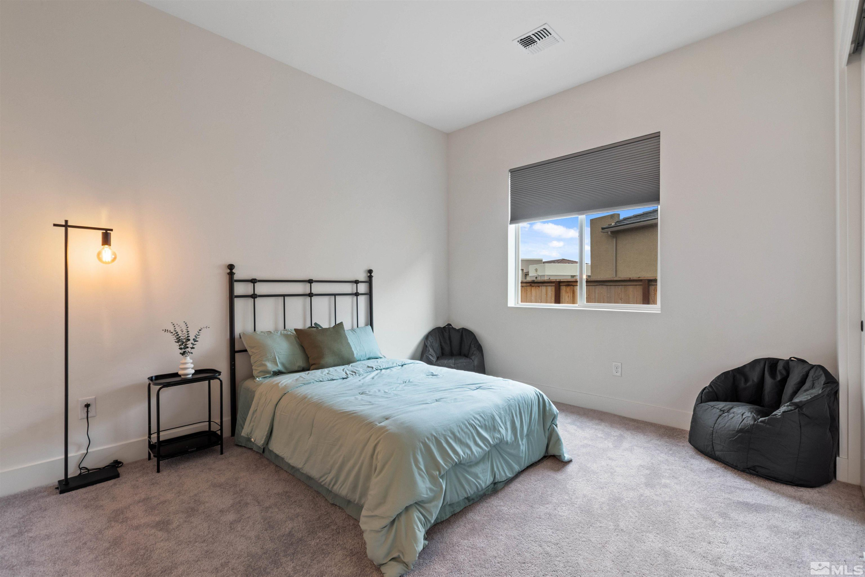 9110 Wild Skies Way Reno, NV 89523 - Photo 35 of 46 a bedroom with a bed and window