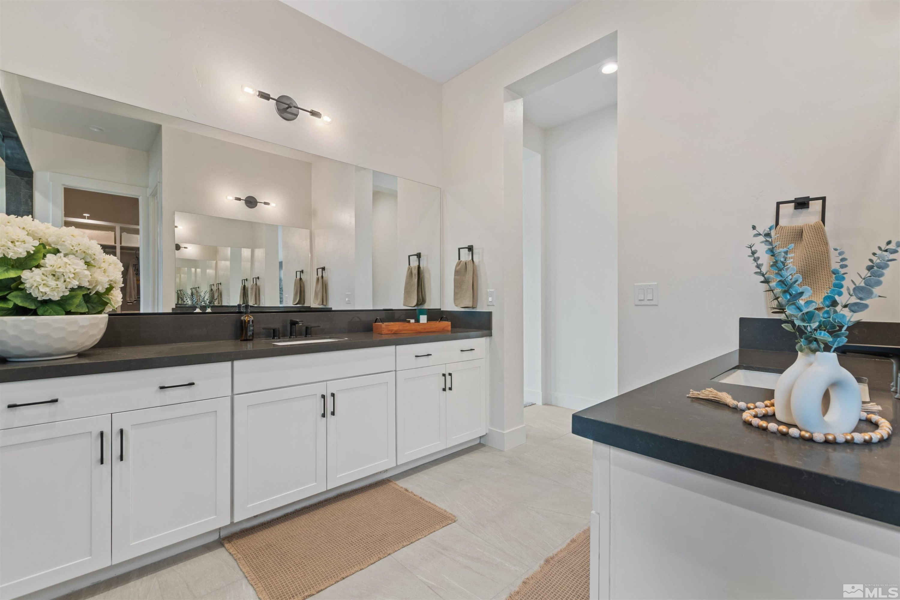 9110 Wild Skies Way Reno, NV 89523 - Photo 40 of 46 a spacious bathroom with sinks and mirror
