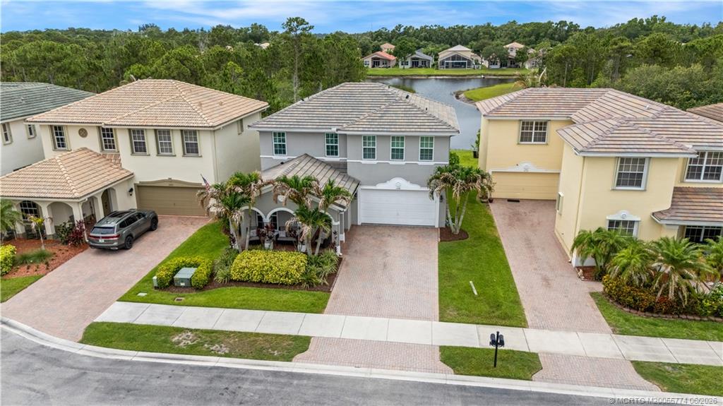 1268 Southeast Kirk Street Stuart, FL 34997 - Photo 51 of 63 a front view of a house with a yard