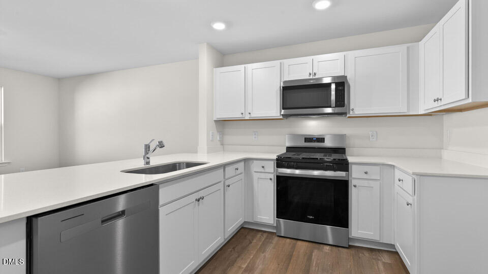 104 Clementine Street Angier, NC 27501 - Photo 3 of 27 a kitchen with stainless steel appliances granite countertop a sink and stove top oven