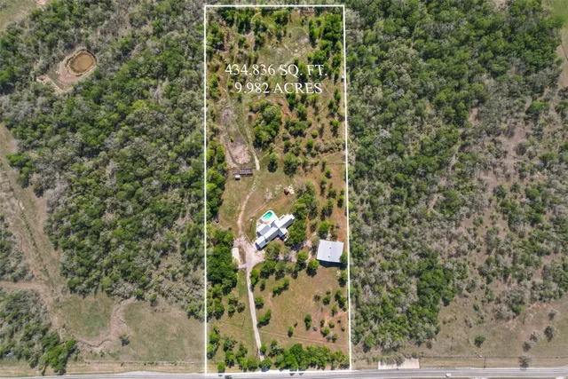a view of a yard with wooden fence