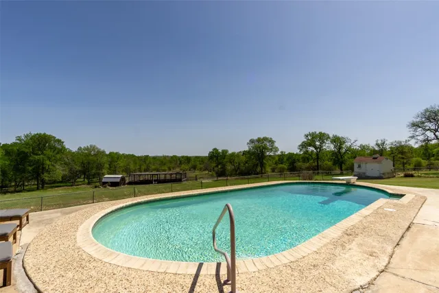 a house with a swimming pool in front of it