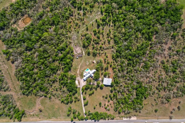 an aerial view of a house with a yard