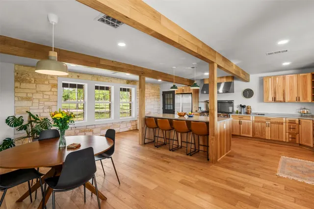 a kitchen with stainless steel appliances a stove a sink a stove and a window