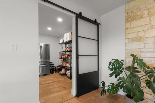 a kitchen with a dining table chairs cabinets and stainless steel appliances