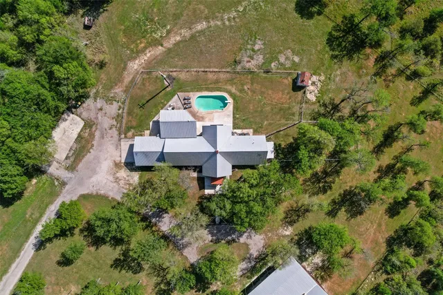 an aerial view of a houses with a yard