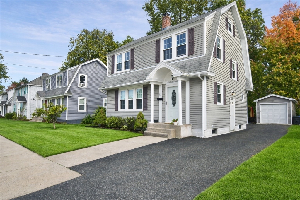 a front view of a house with a yard and garage