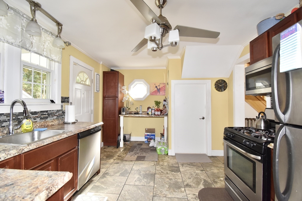 77 Dorset Street Springfield, MA 01108 - Photo 5 of 34 a large kitchen with stainless steel appliances granite countertop a sink dishwasher stove and refrigerator