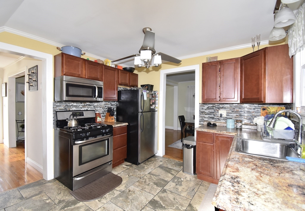 77 Dorset Street Springfield, MA 01108 - Photo 6 of 34 a kitchen with stainless steel appliances granite countertop a stove refrigerator and a sink