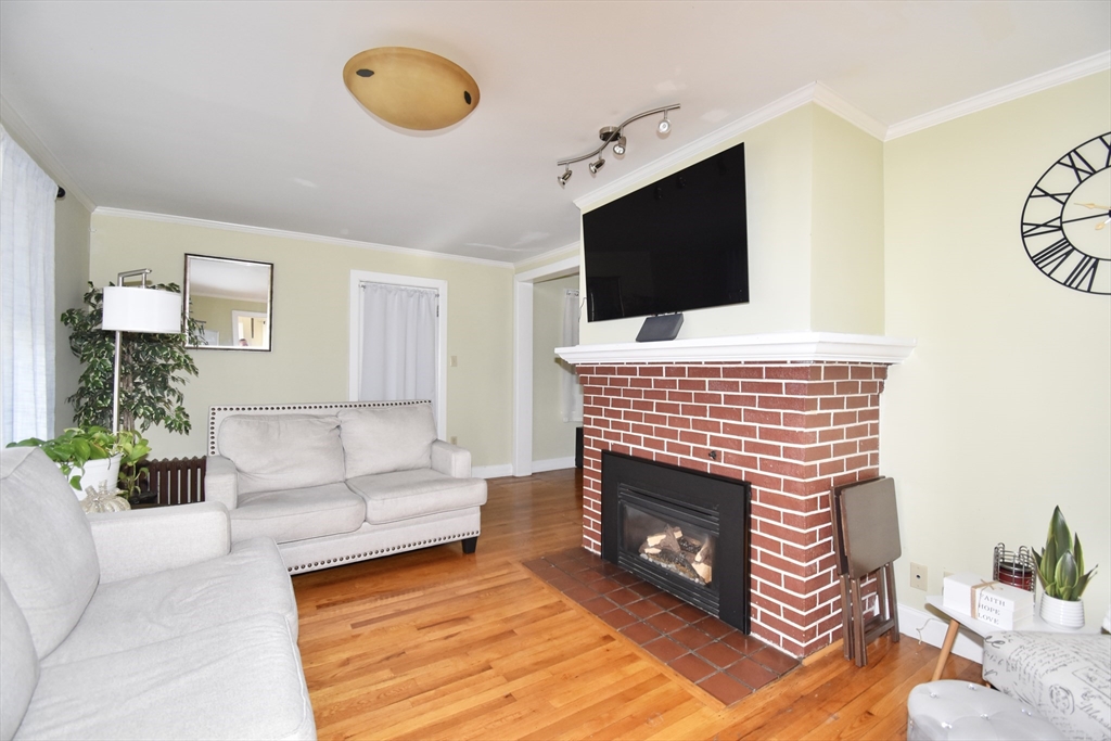 77 Dorset Street Springfield, MA 01108 - Photo 9 of 34 a living room with furniture and a fireplace