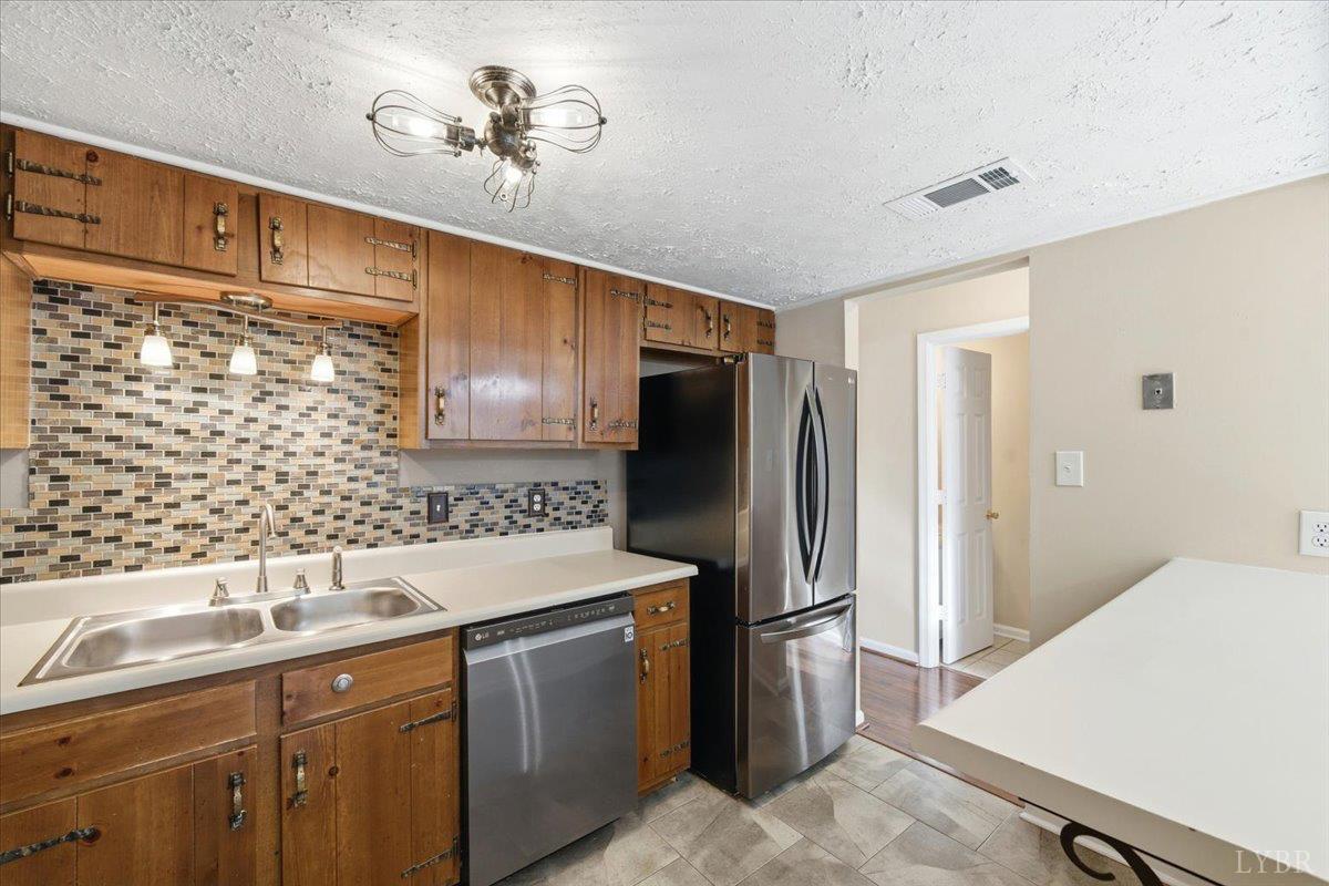 154 Kitty Hawk Square Lynchburg, VA 24502 - Photo 11 of 30 a kitchen with stainless steel appliances a sink and a refrigerator