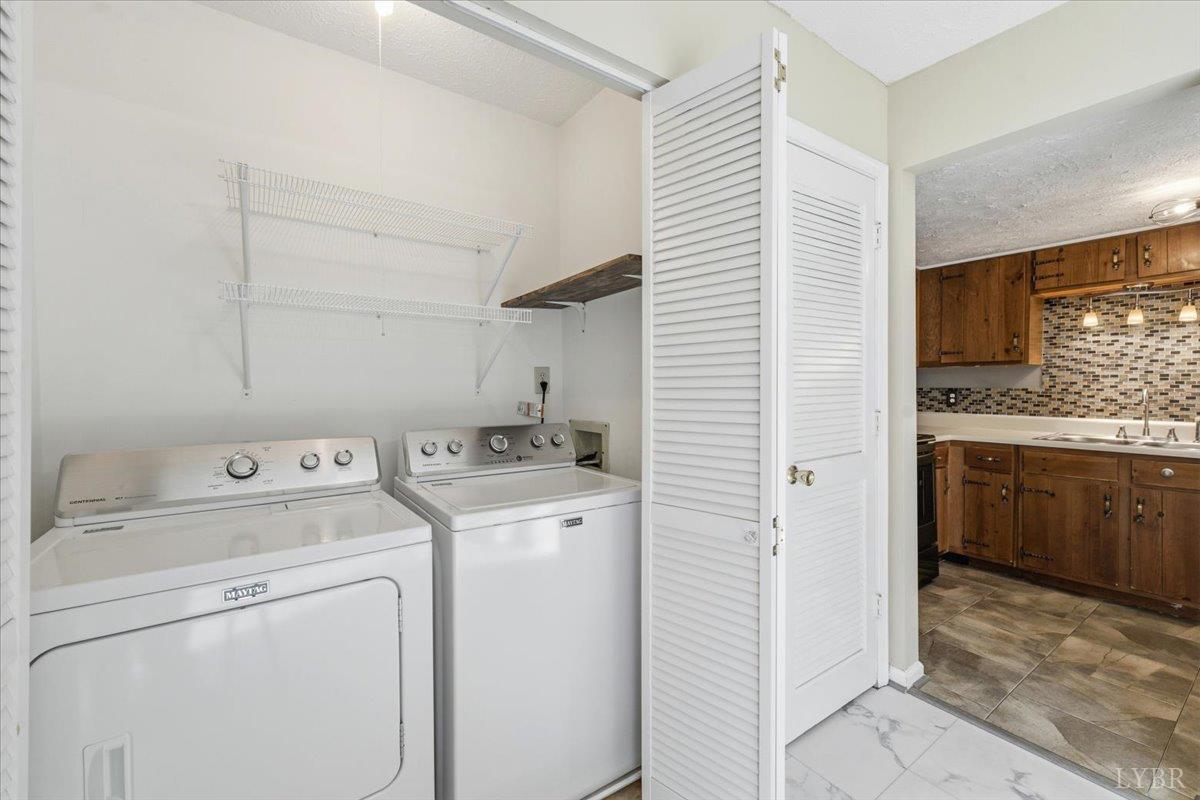 154 Kitty Hawk Square Lynchburg, VA 24502 - Photo 14 of 30 a view of washer and dryer with kitchen in the background