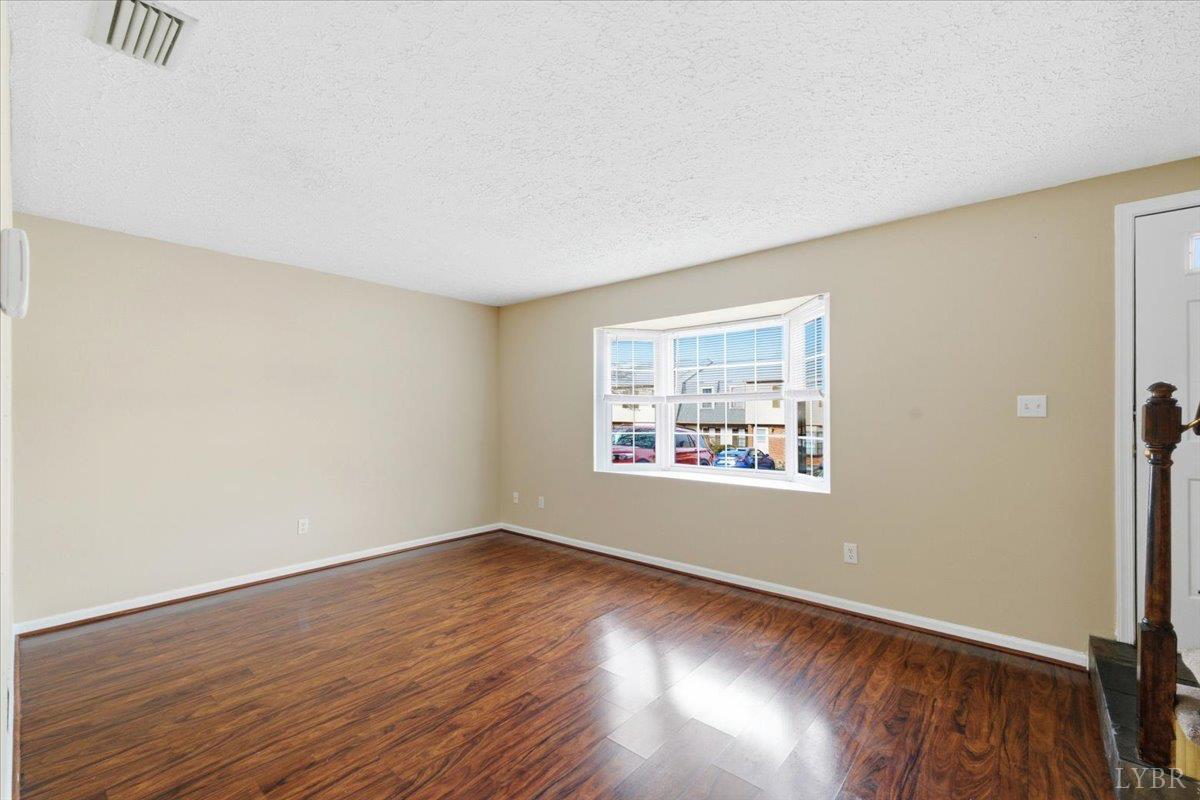 154 Kitty Hawk Square Lynchburg, VA 24502 - Photo 5 of 30 an empty room with wooden floor and windows