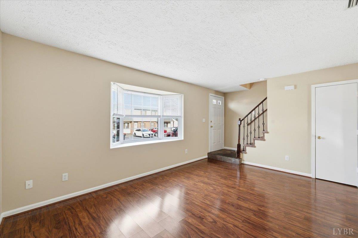 154 Kitty Hawk Square Lynchburg, VA 24502 - Photo 6 of 30 a view of an empty room with wooden floor and a window