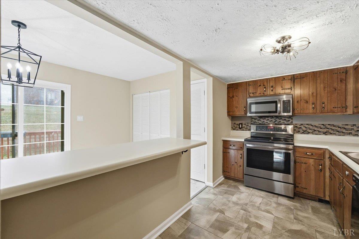 154 Kitty Hawk Square Lynchburg, VA 24502 - Photo 9 of 30 a kitchen with stainless steel appliances granite countertop a stove and a sink