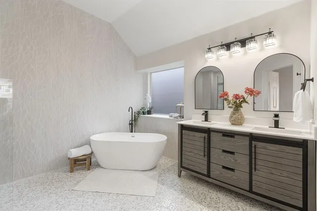 a spacious bathroom with a double vanity sink and a mirror