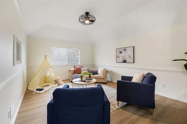 a living room with furniture rug and wooden floor