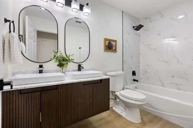 a bathroom with a toilet sink and mirror