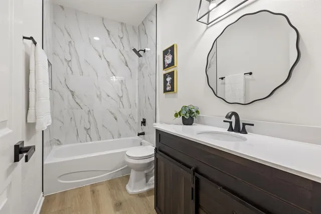 a bathroom with a sink a toilet and a mirror