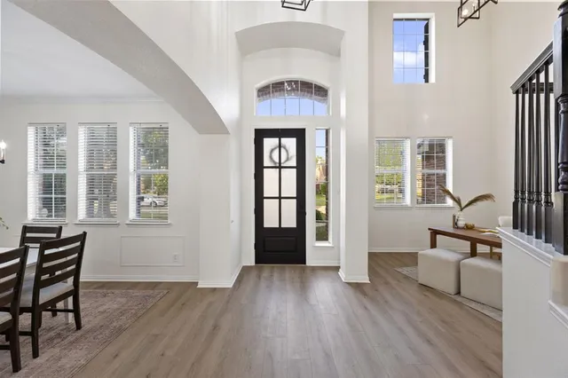 a view of an entryway with wooden floor and a front door