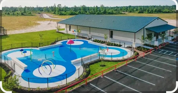 a view of a swimming pool with a patio and a yard