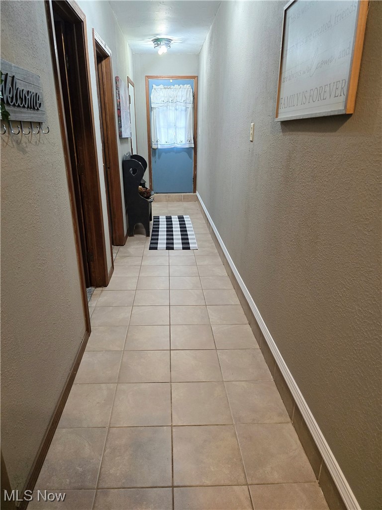 1550 North County Line Road Geneva, OH 44041 - Photo 28 of 47 Corridor featuring light tile floors