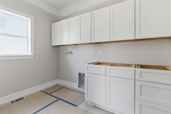 a view of a storage and utility room with closet