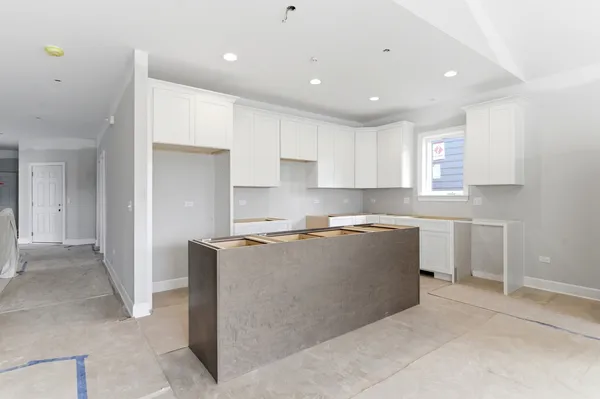 a large kitchen with stainless steel appliances granite countertop a refrigerator a sink and a stove