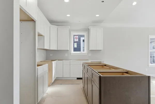 a utility room with cabinets washer and dryer