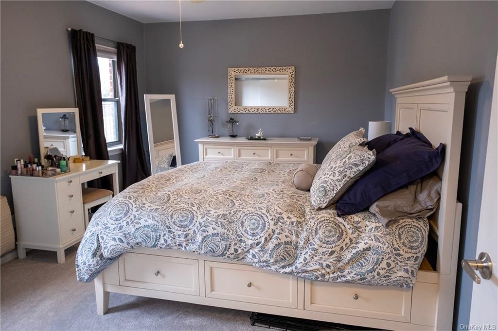 a bedroom with a bed and a dresser in it