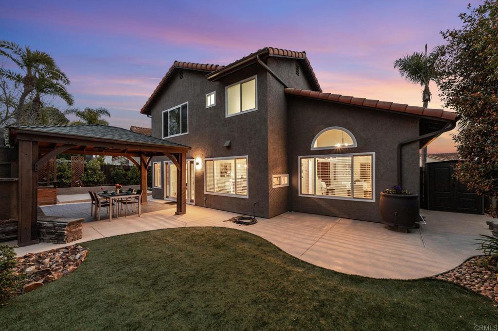 a view of a house with a yard patio and a garden