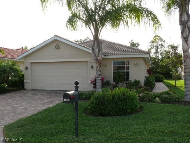 19624 Villa Rosa Loop Fort Myers, FL 33967 - Photo 1 of 8 a backyard of a house with potted plants and palm trees
