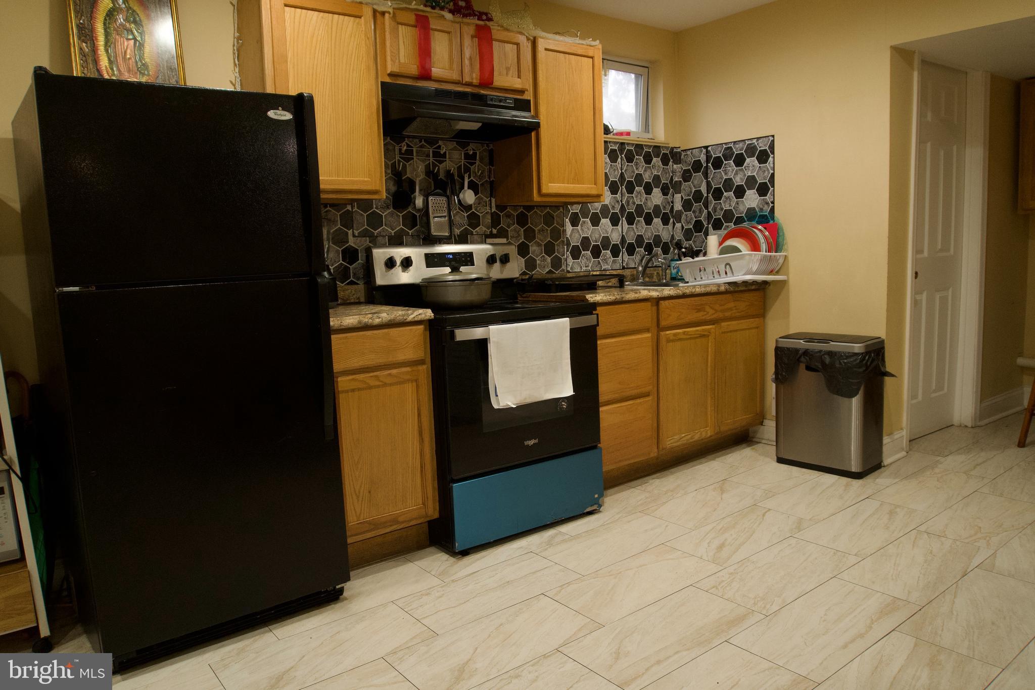 5702 Landover Road Hyattsville, MD 20784 - Photo 13 of 18 a kitchen with stainless steel appliances granite countertop a refrigerator and a stove