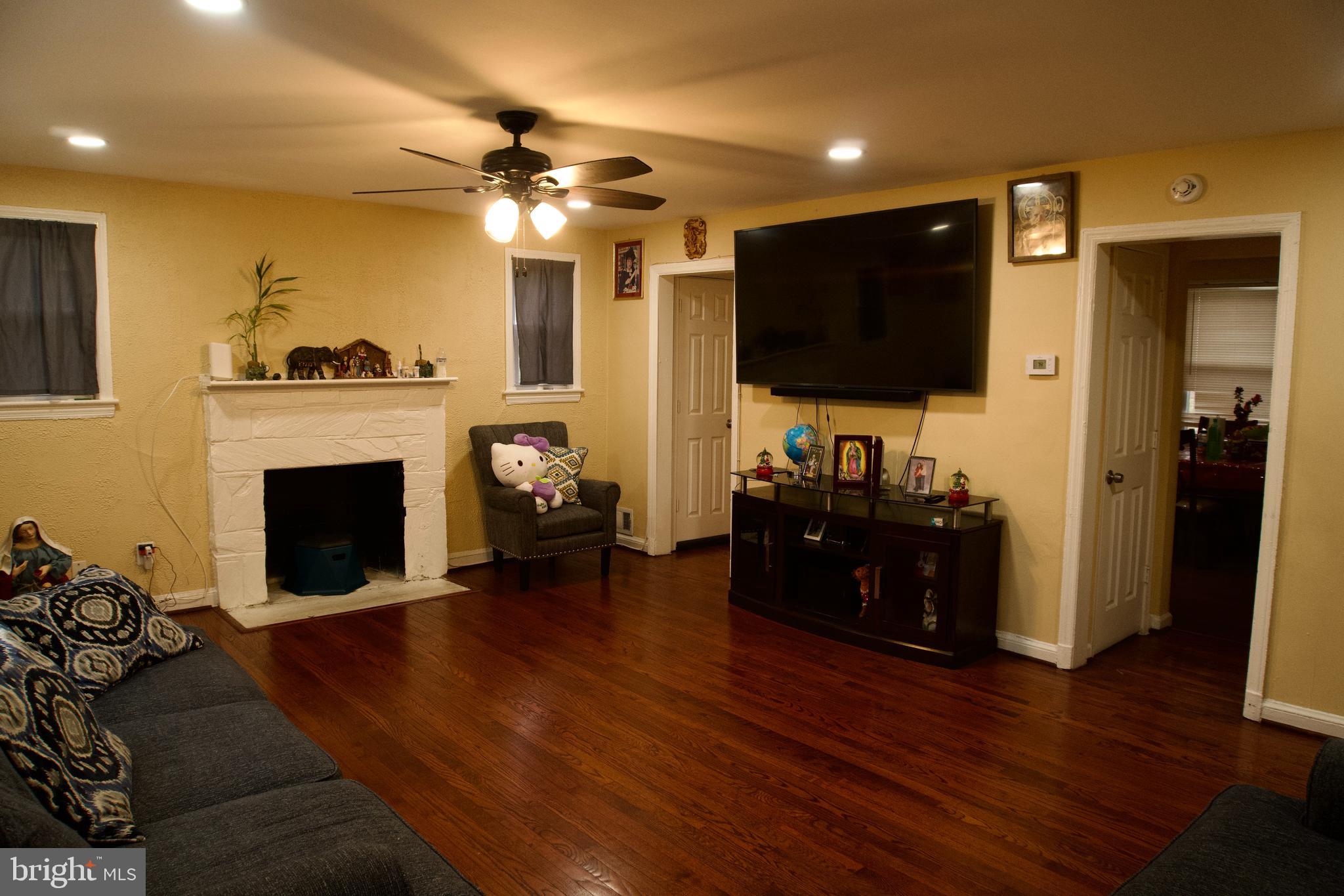5702 Landover Road Hyattsville, MD 20784 - Photo 3 of 18 a living room with furniture and a flat screen tv