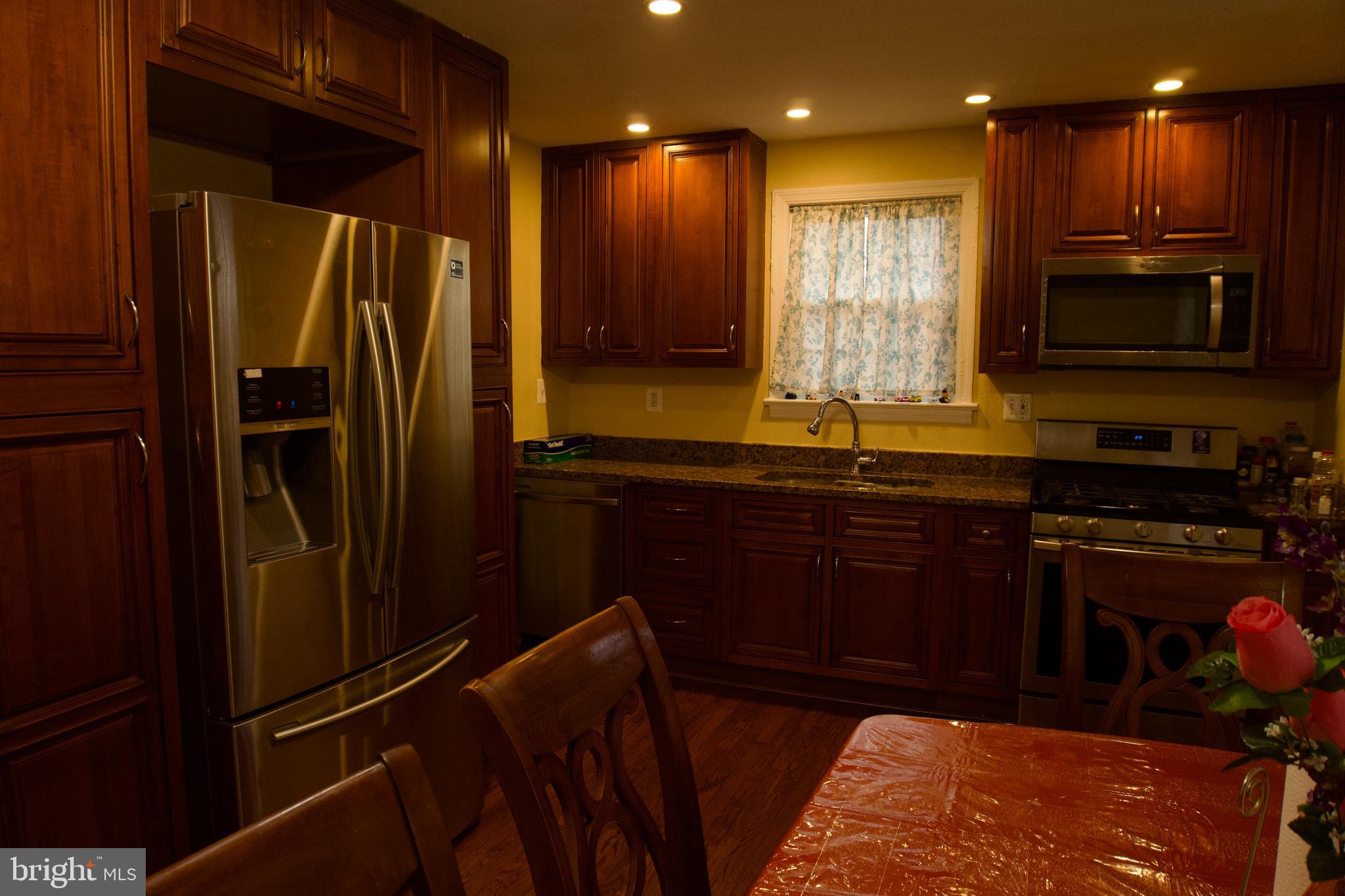 5702 Landover Road Hyattsville, MD 20784 - Photo 6 of 18 a kitchen with stainless steel appliances granite countertop a refrigerator and a sink