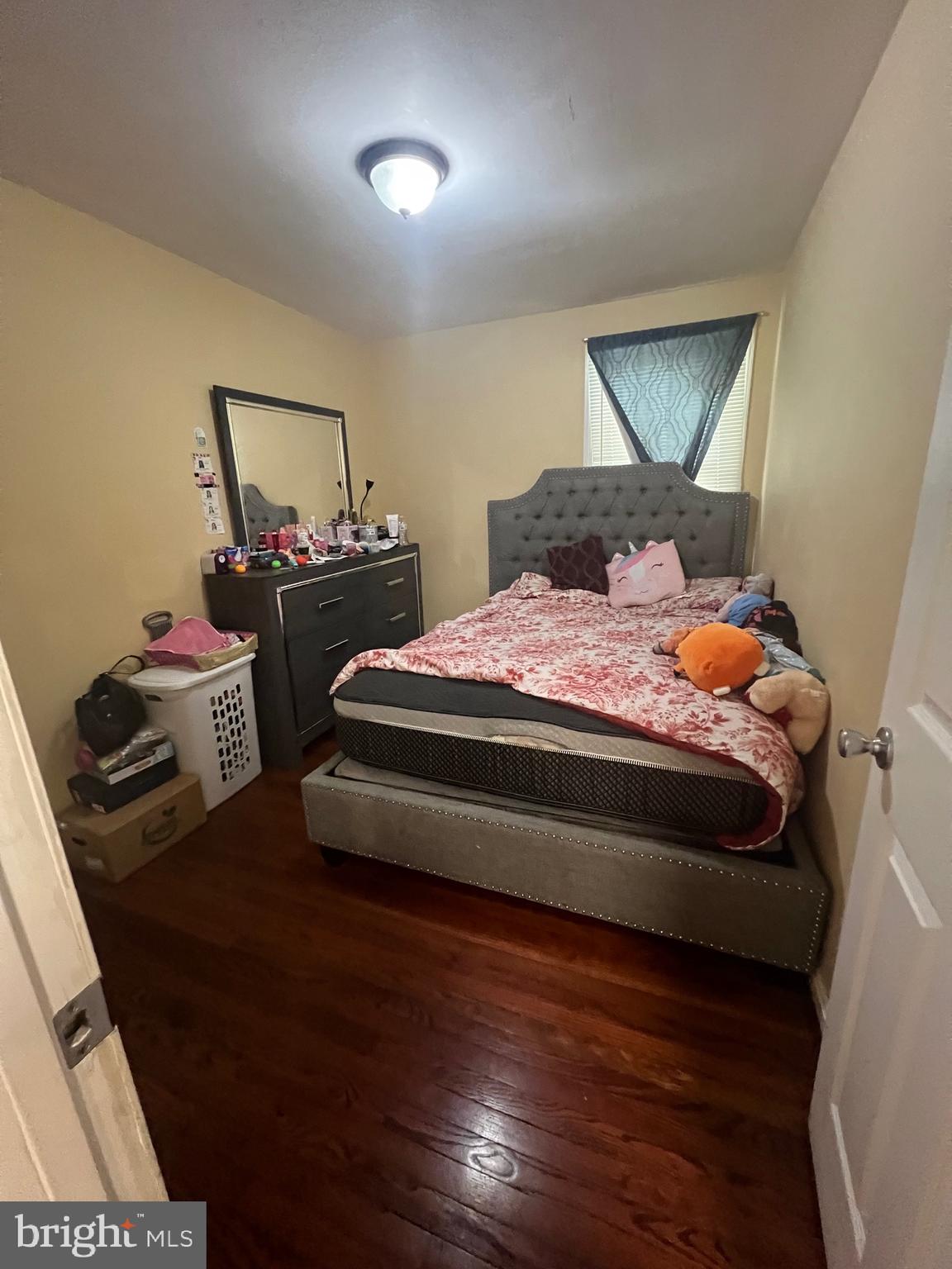 5702 Landover Road Hyattsville, MD 20784 - Photo 9 of 18 a bedroom with a bed and wooden floor
